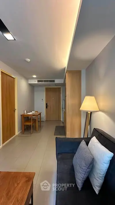 Modern living room with sleek furniture and ambient lighting in a stylish apartment.
