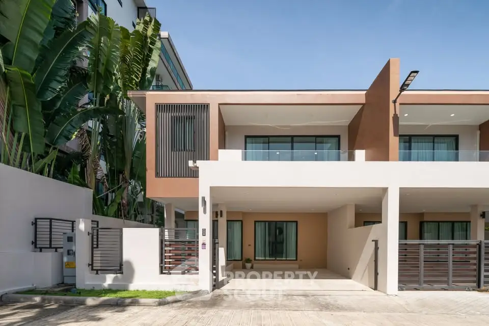 Modern two-story townhouse with sleek design and spacious driveway in a serene neighborhood.