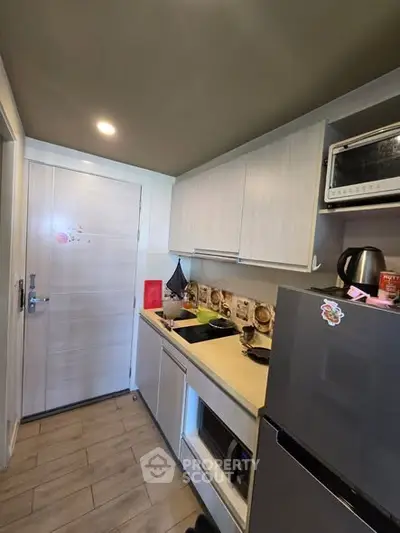 Modern compact kitchen with sleek cabinets and appliances