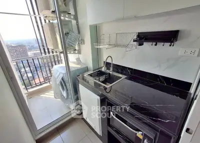 Modern kitchen with sleek black countertops and city view balcony
