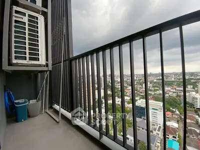 High-rise balcony with city view and air conditioning unit, perfect for urban living.