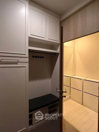 Spacious storage area with elegant cabinetry and seating in modern home