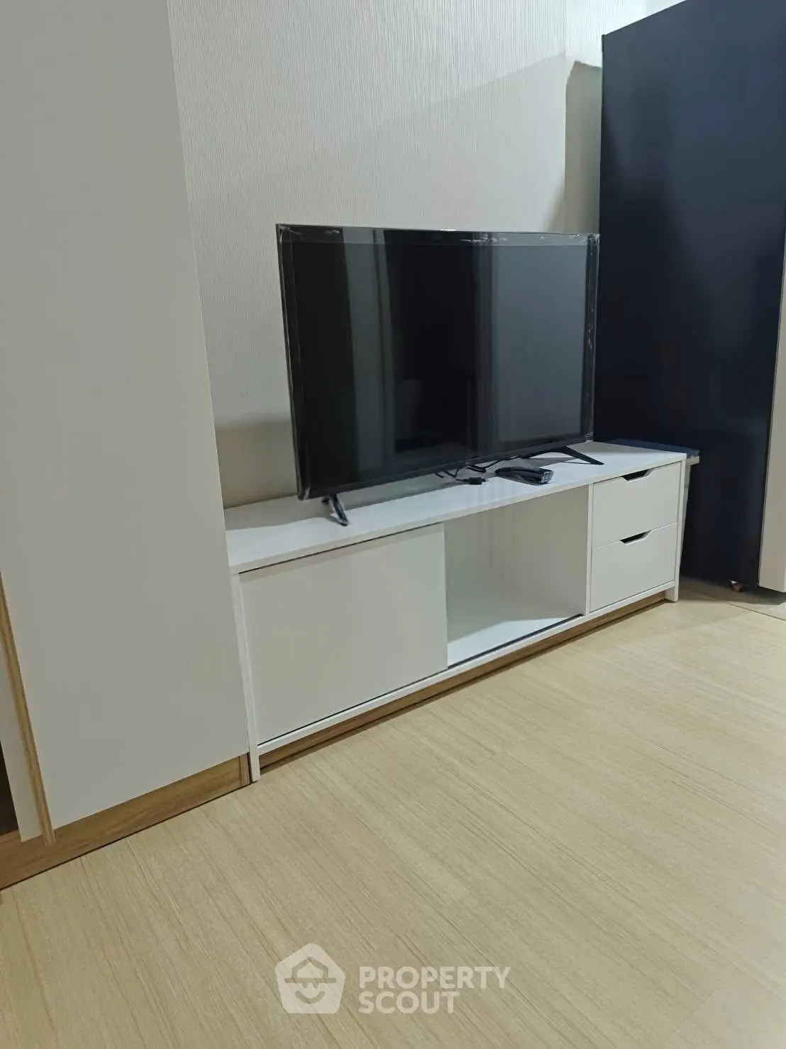 Modern living room with sleek TV stand and flat-screen television
