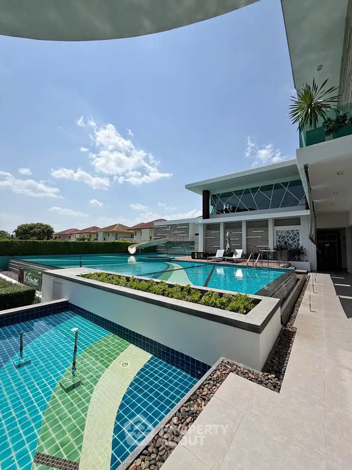 Luxurious modern poolside view with sleek architecture and sunny skies, perfect for relaxation and entertainment.