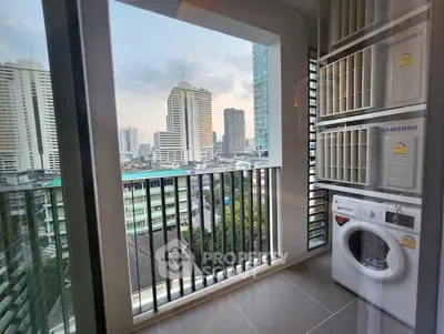 Modern apartment balcony with city view and laundry appliances, perfect for urban living.