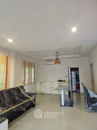 Spacious modern living room with sleek furniture and open layout, perfect for contemporary living.