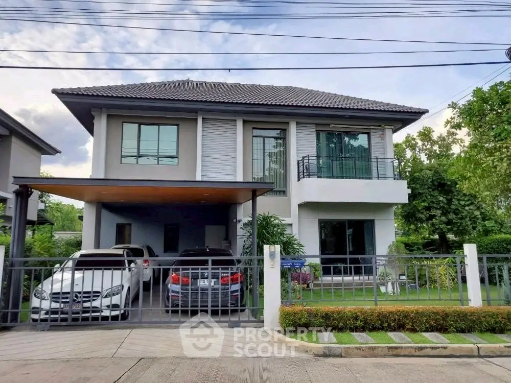 Modern two-story house with spacious driveway and lush garden in a serene neighborhood.