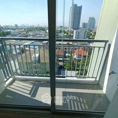 Charming balcony with cityscape view from high-rise apartment, perfect for urban living enthusiasts.