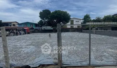 Vacant land plot ready for development in a residential neighborhood.