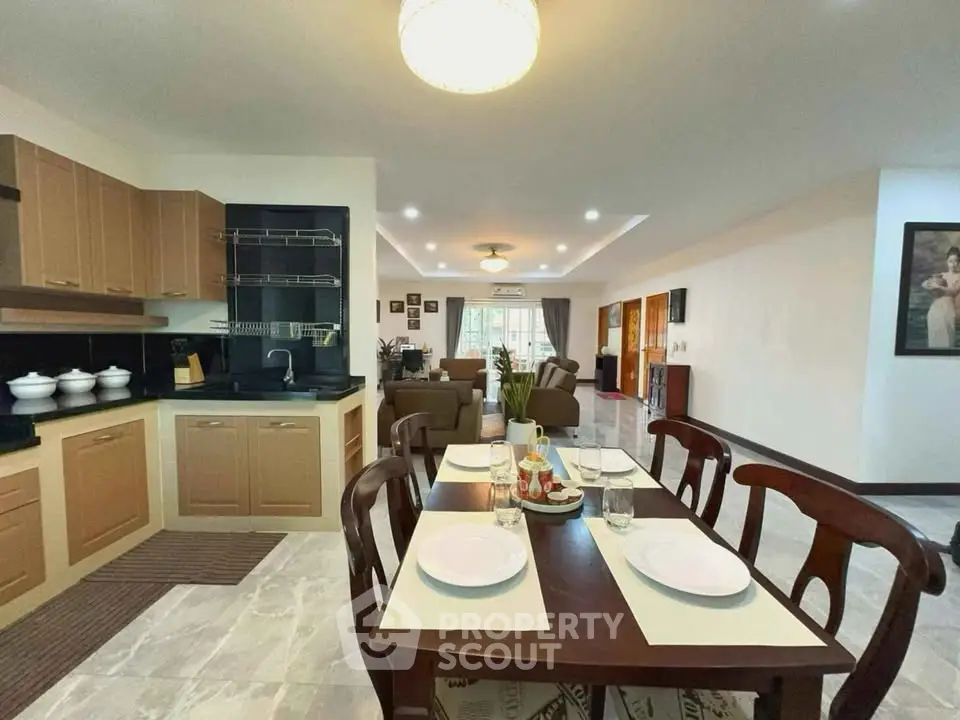 Spacious open-layout kitchen and living room with elegant dining area.