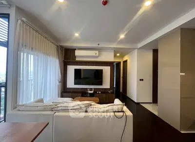 Modern living room with sleek design and large windows offering natural light.