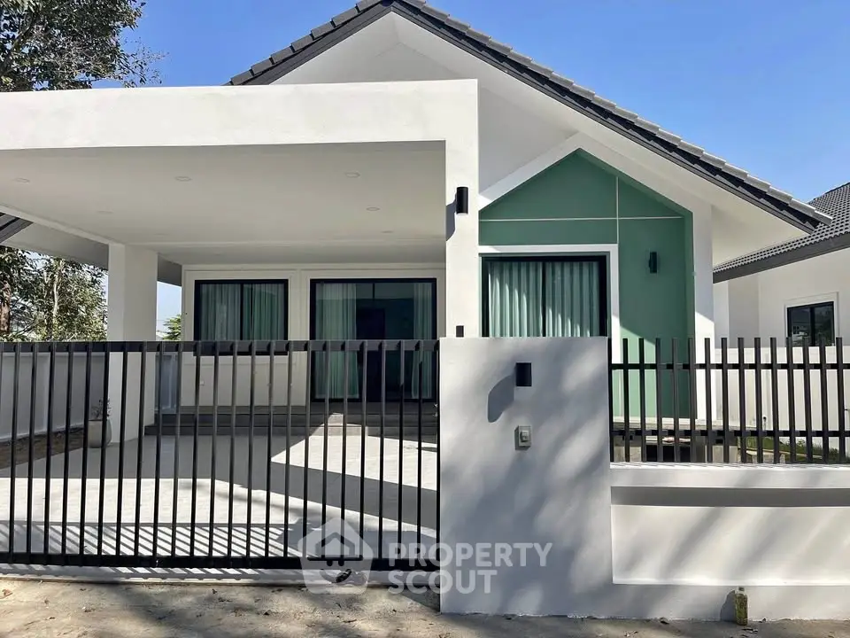 Modern single-story house with sleek design and spacious driveway
