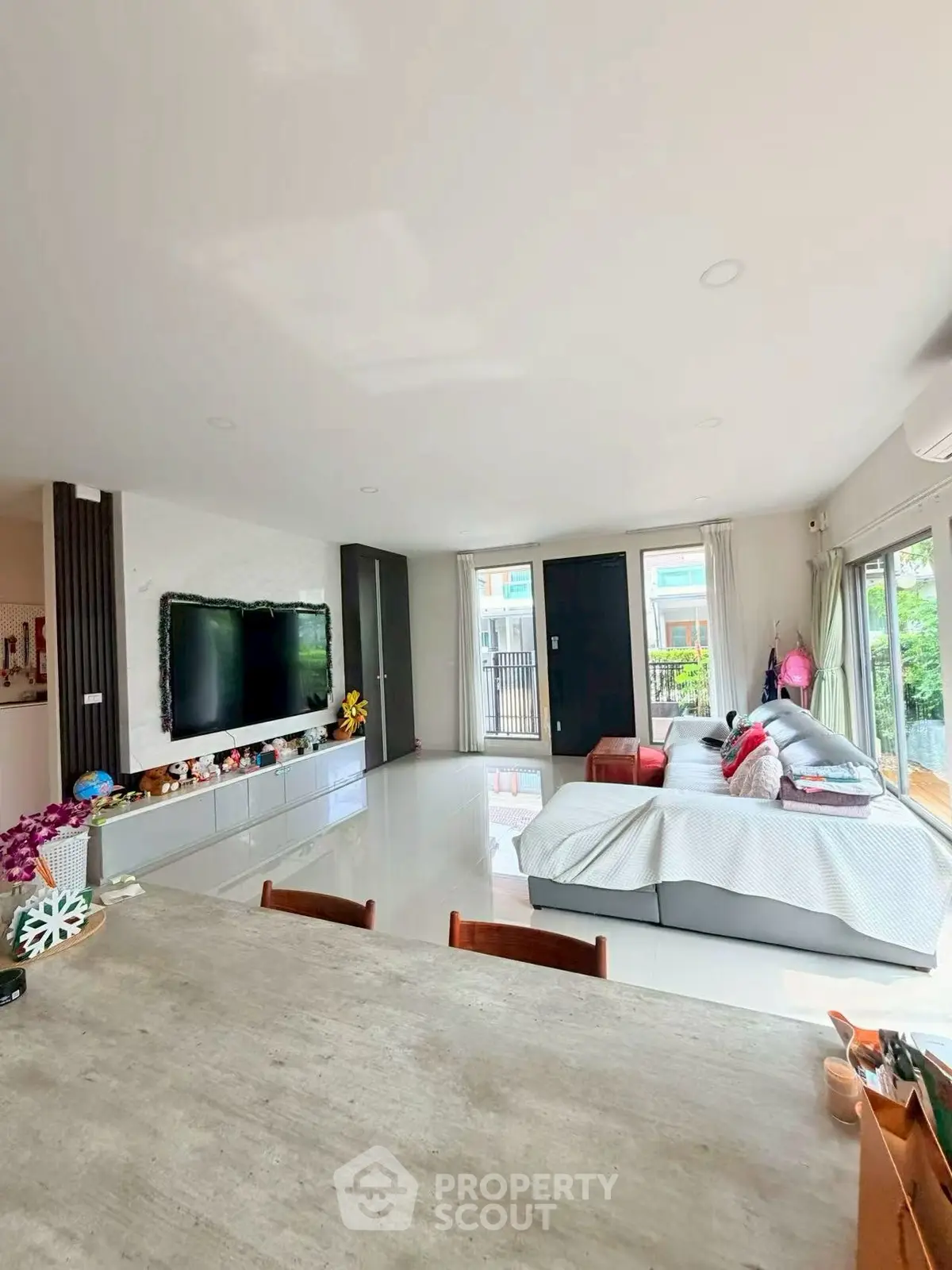 Spacious modern living room with large windows and stylish decor