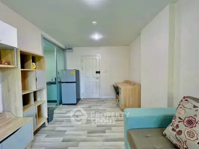 Modern living room with stylish furniture and open layout, featuring a cozy sofa and sleek wooden flooring.