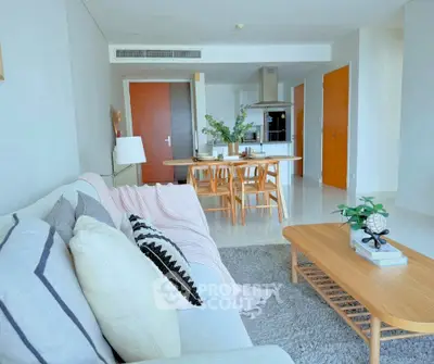 Modern open-plan living room with cozy decor and dining area