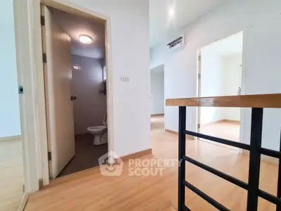 Spacious interior with wooden flooring and modern bathroom in a bright home.