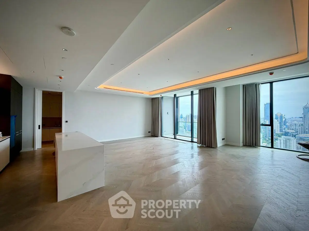Spacious modern living room with panoramic city views and elegant wood flooring.