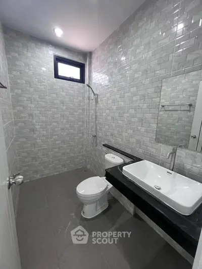 Modern bathroom with sleek gray tiles and contemporary fixtures