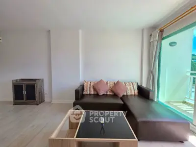 Spacious living room with modern sofa and large window view