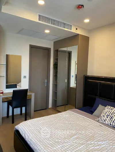Modern bedroom with stylish decor and built-in wardrobe in a contemporary apartment.