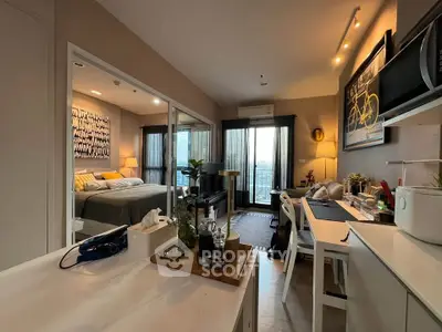 Modern open-plan apartment with stylish decor and natural light, featuring a cozy bedroom and functional kitchen.