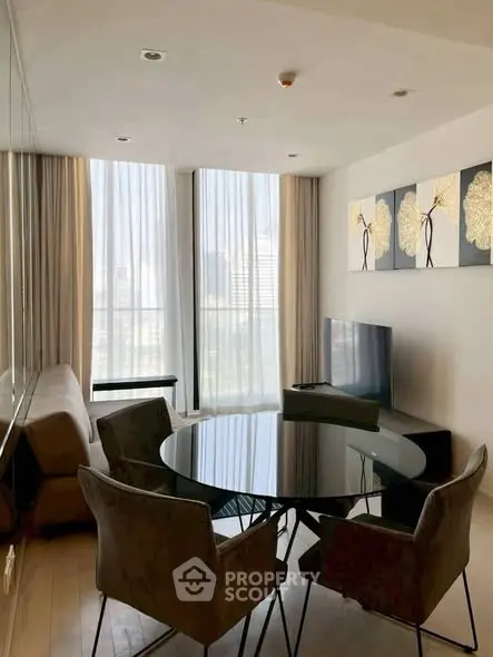 Modern living room with floor-to-ceiling windows and stylish decor in a high-rise apartment.