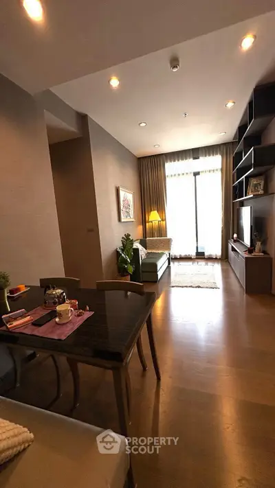 Modern living room with elegant decor and natural light, featuring a cozy seating area and stylish dining space.