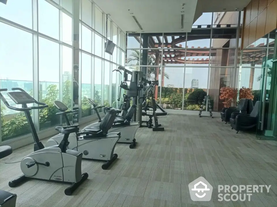 Luxurious high-rise gym with panoramic city views and modern fitness equipment.