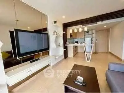 Modern living room with open kitchen and stylish decor in a contemporary apartment.