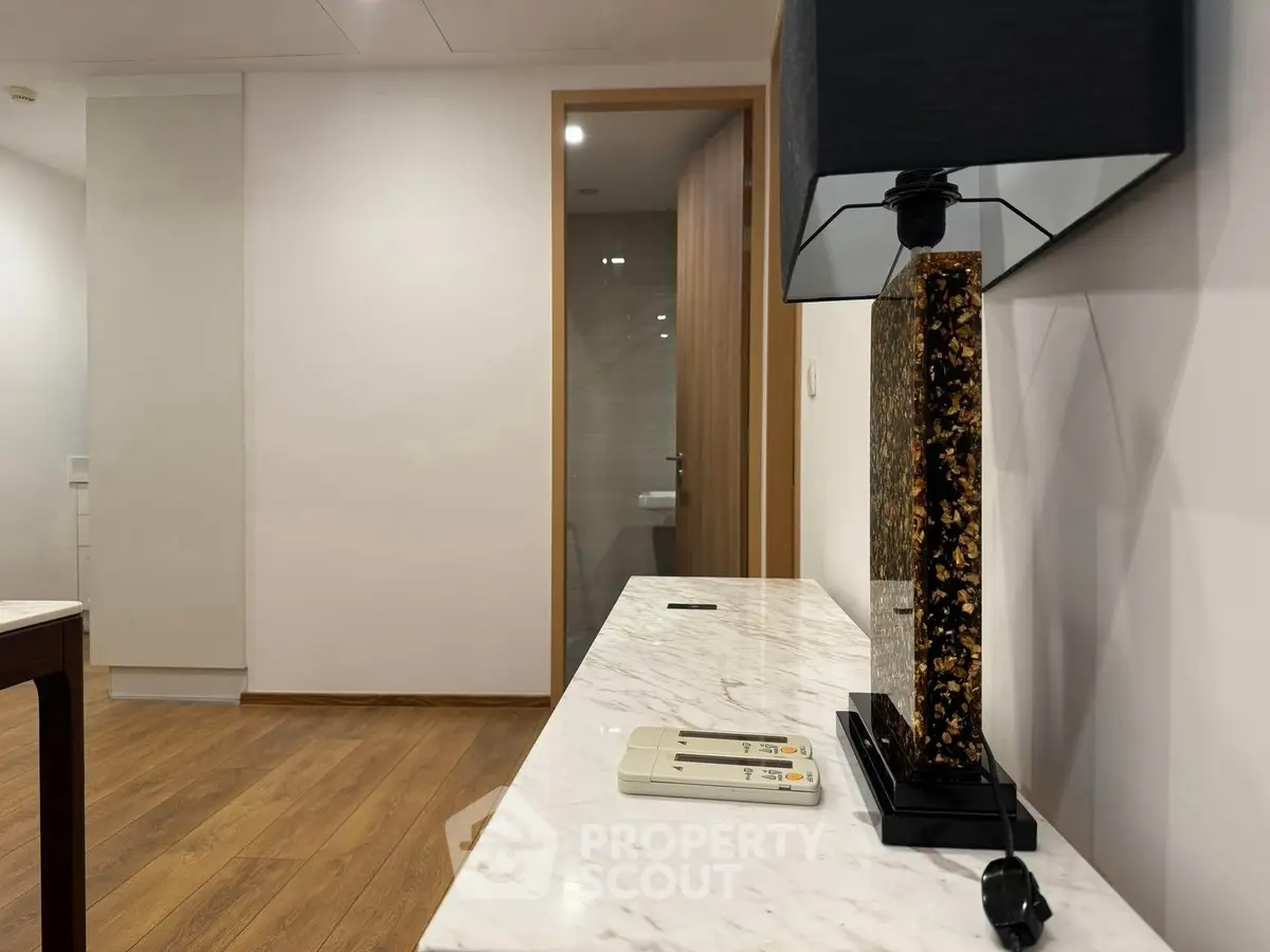 Modern interior with elegant marble console and stylish lamp in a contemporary apartment.