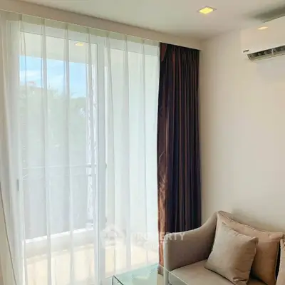 Bright living room with cozy seating and balcony view