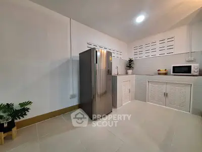 Modern kitchen with sleek stainless steel fridge and minimalist design