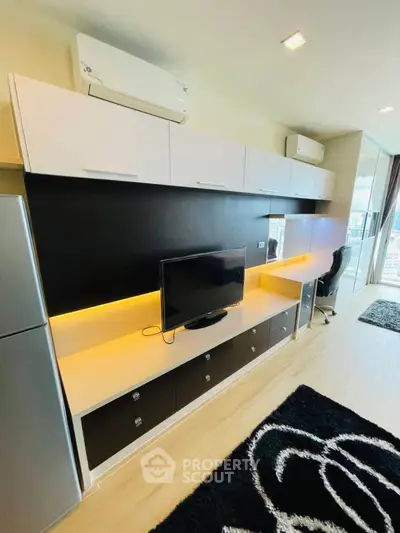 Modern living room with sleek TV unit and balcony view