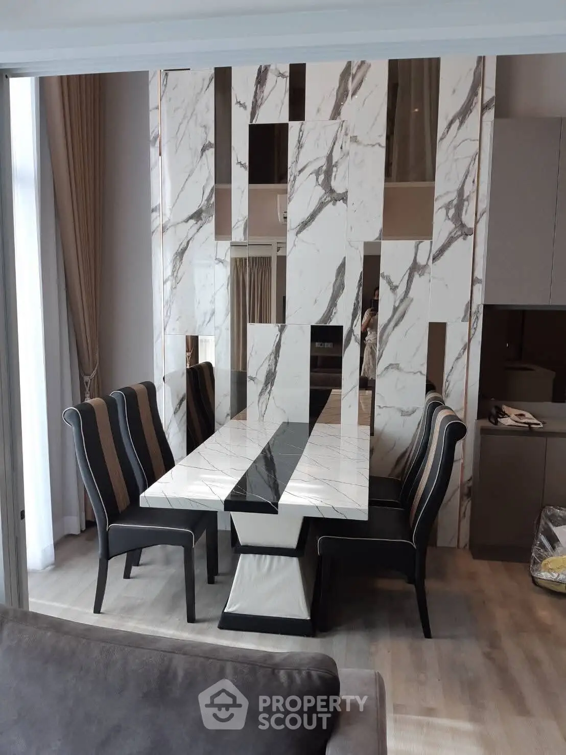 Elegant dining area with marble accents and stylish seating in modern apartment