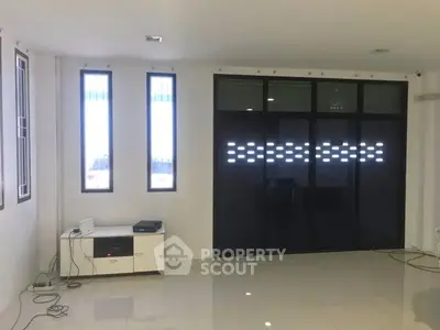 Spacious modern living room with sleek design and large windows