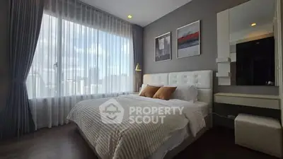 Luxurious bedroom with large window and elegant decor in modern apartment