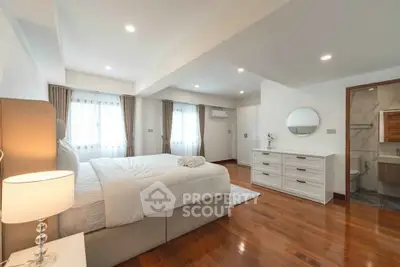 Spacious and elegant bedroom with modern furnishings and natural light.
