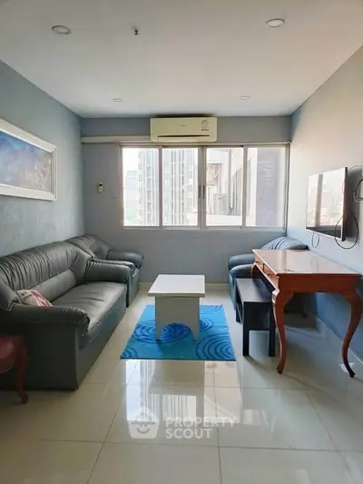 Cozy living room with modern furniture and city view, perfect for relaxation.