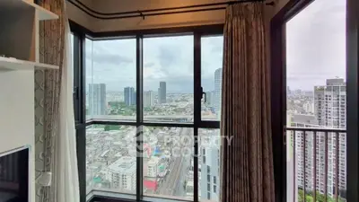 Stunning high-rise apartment with panoramic city views from a spacious corner window.