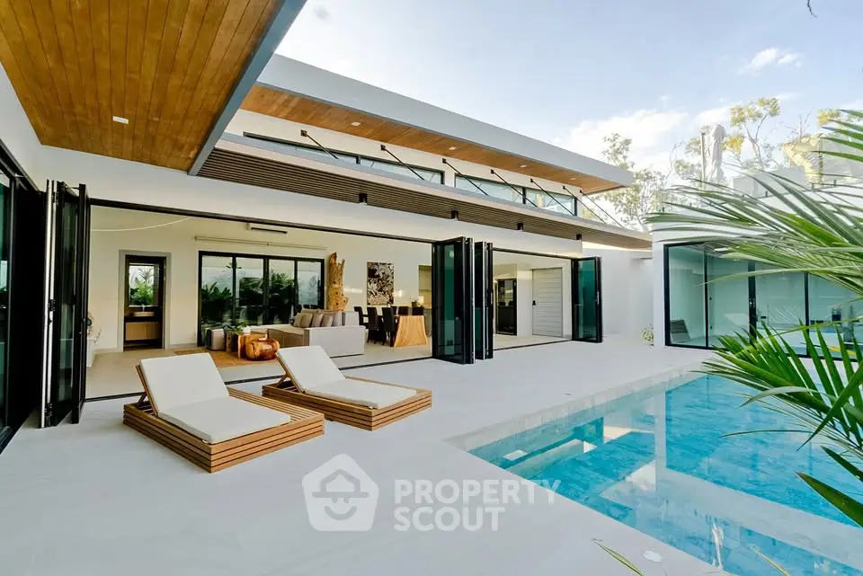 Luxurious modern villa with pool and open living area, perfect for relaxation and entertaining.