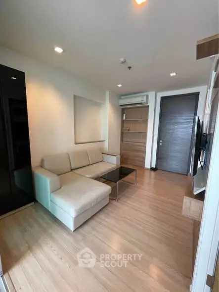 Modern living room with sleek design and cozy furniture in a stylish apartment.