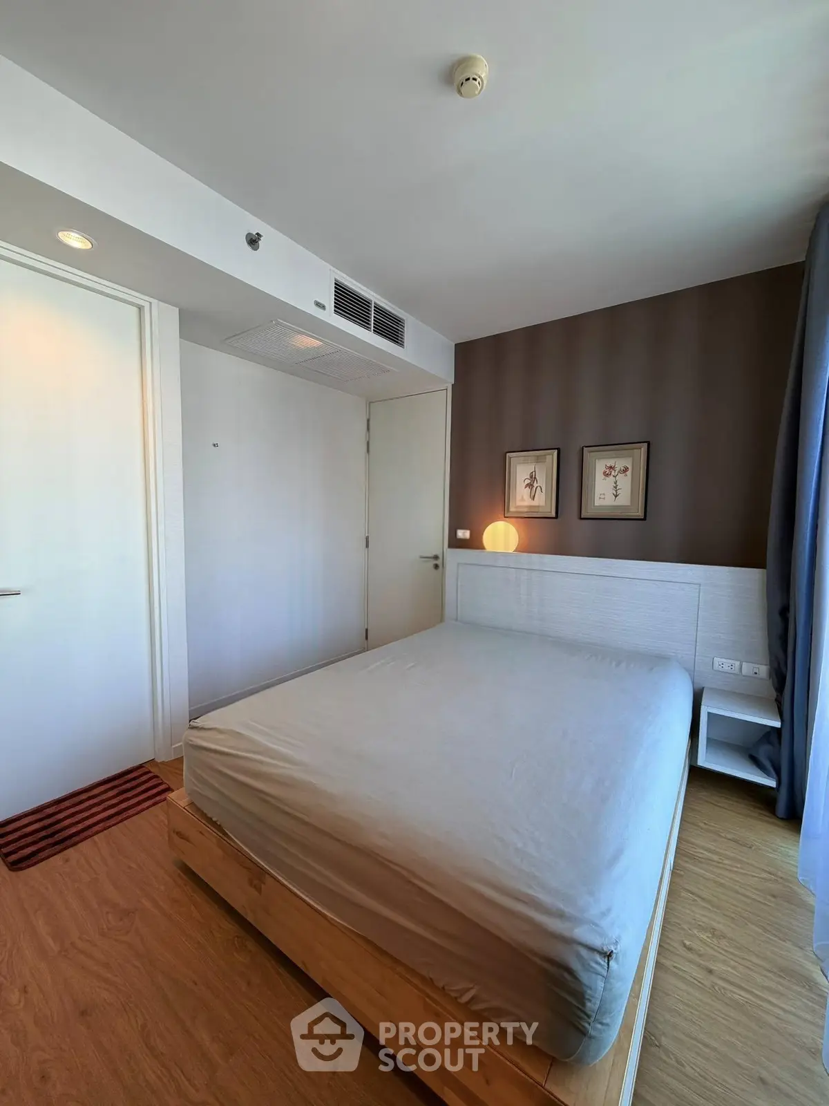 Modern bedroom with minimalist decor and wooden flooring