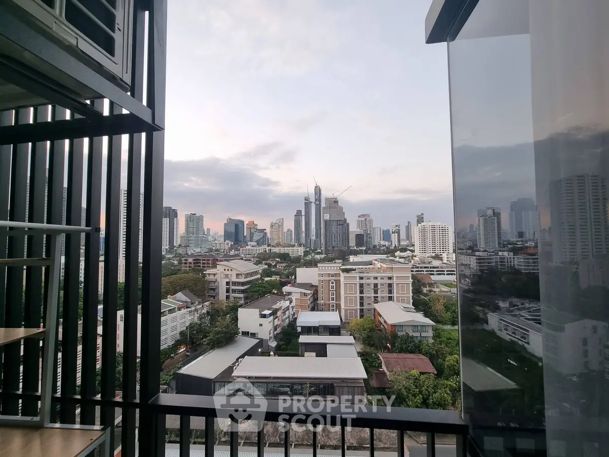 Stunning cityscape view from a modern balcony in a high-rise building, showcasing urban living at its finest.