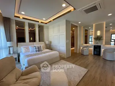 Luxurious modern bedroom with elegant decor and spacious layout, featuring cozy seating area and ambient lighting.
