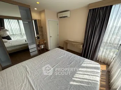Modern bedroom with large window and stylish furniture in a high-rise apartment.
