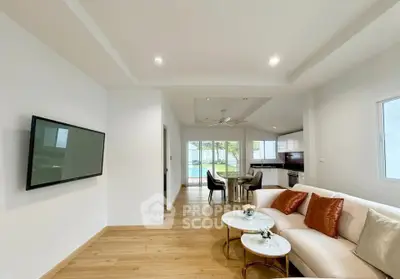 Spacious modern living room with open layout and elegant decor, featuring a view of the dining area and kitchen.
