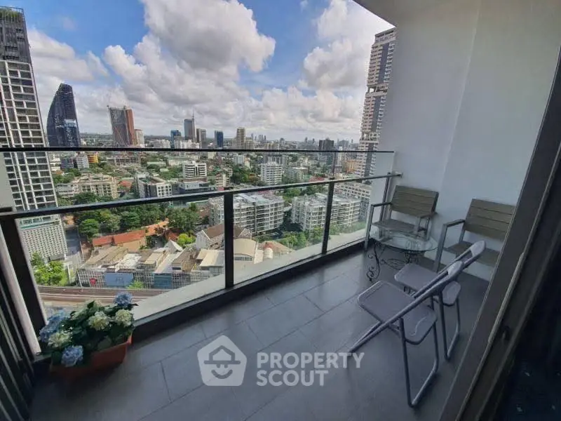 Stunning city view from a high-rise balcony with modern seating.