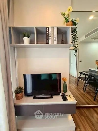 Modern living room with sleek TV unit and stylish decor in a contemporary apartment.