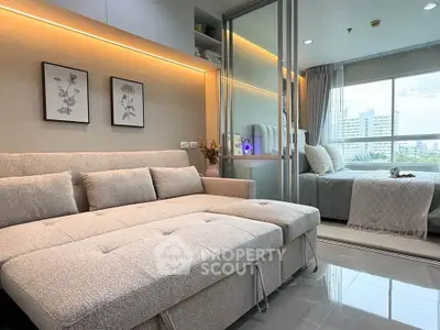 Modern living room with cozy sofa and bedroom view in stylish apartment