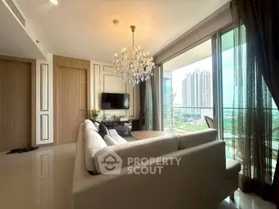 Luxurious living room with chandelier and stunning city view from large windows.